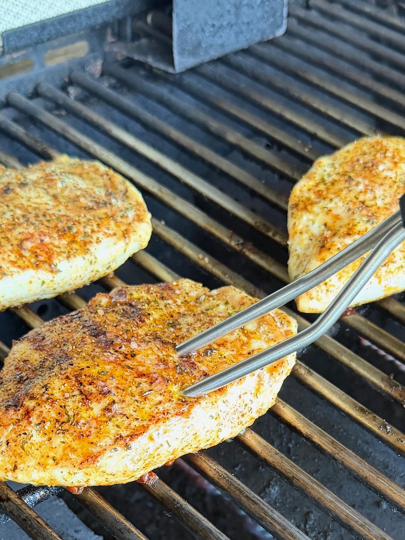 Meat thermometer testing the chicken breast for doneness. 