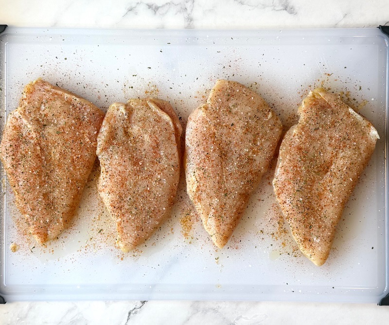 Chicken breasts seasoned and coated with olive oil. 