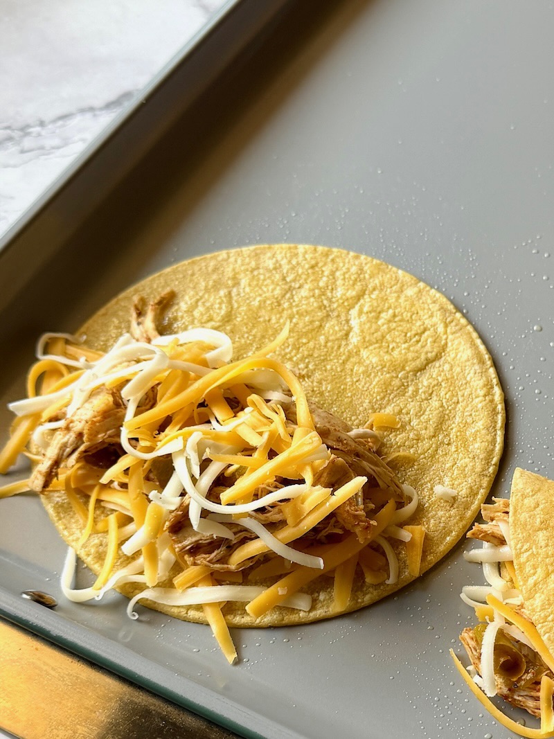 Corn tortilla stuffed with cheese and chicken mixture. 