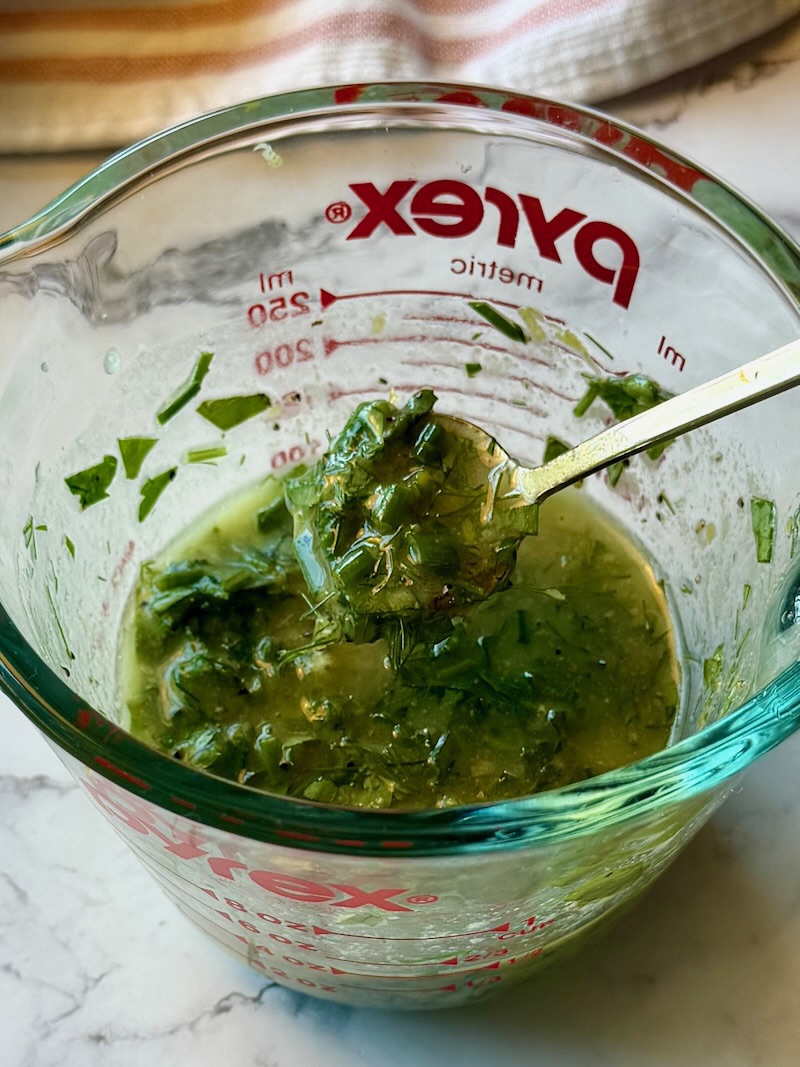 Lemon herb dressing combined in a small bowl. 