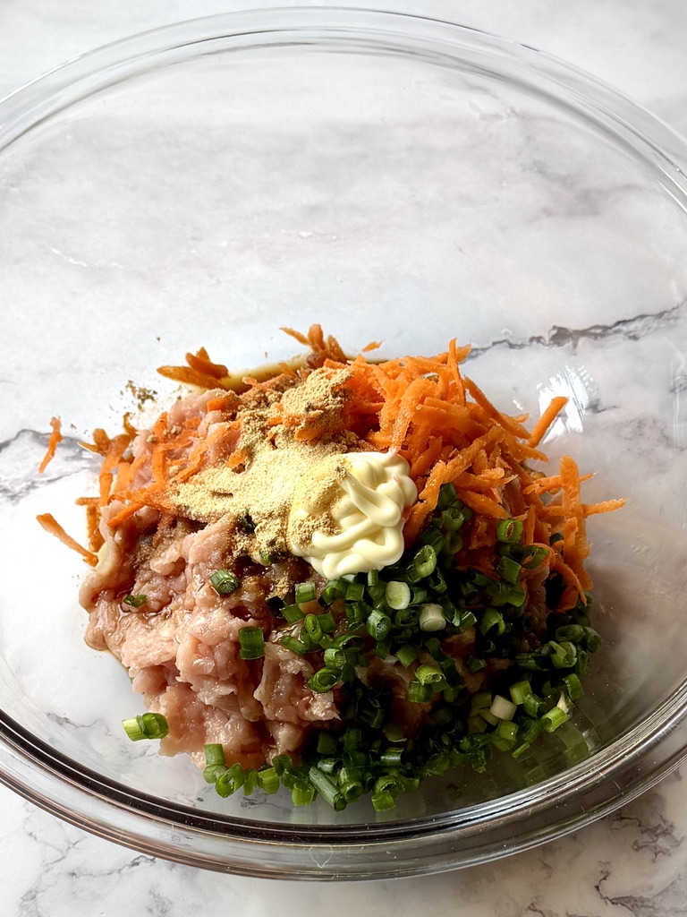 Ground chicken and filling ingredients in a mixing bowl