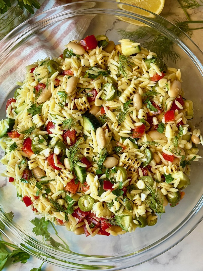 Summer glow orzo salad prepared in a bowl. 