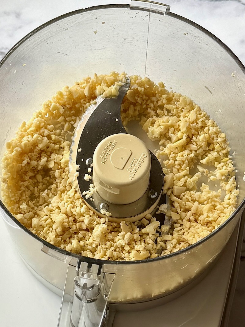 Garlic and almonds blended in a food processor until coarse crumbs. 