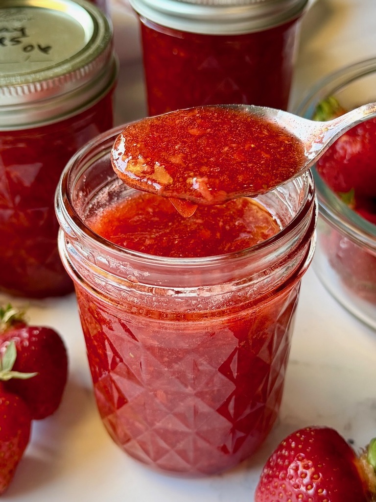 strawberry jam in a jar with a spoon