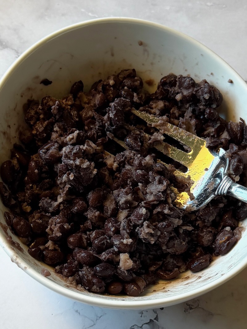 lightly smashed black beans