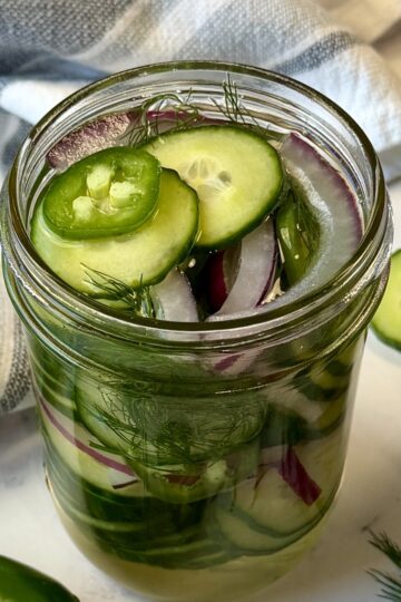 pickled cucumbers and onions in a mason jar