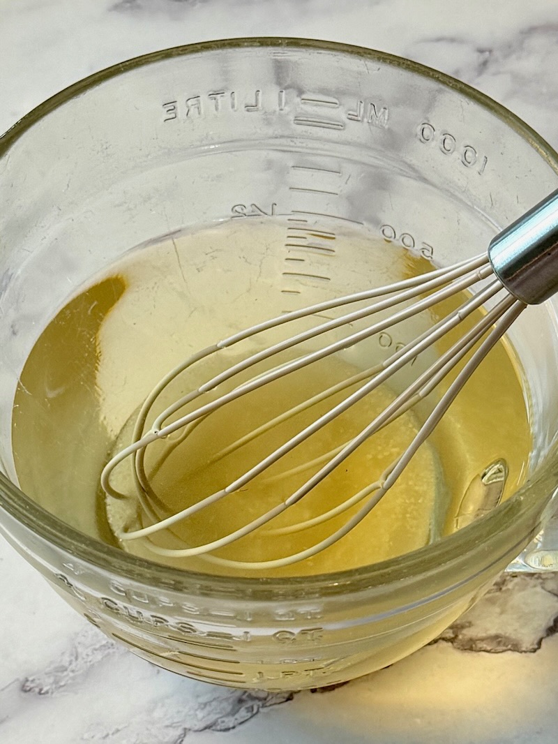Vinegar, water, sugar, and salt combined in a bowl.