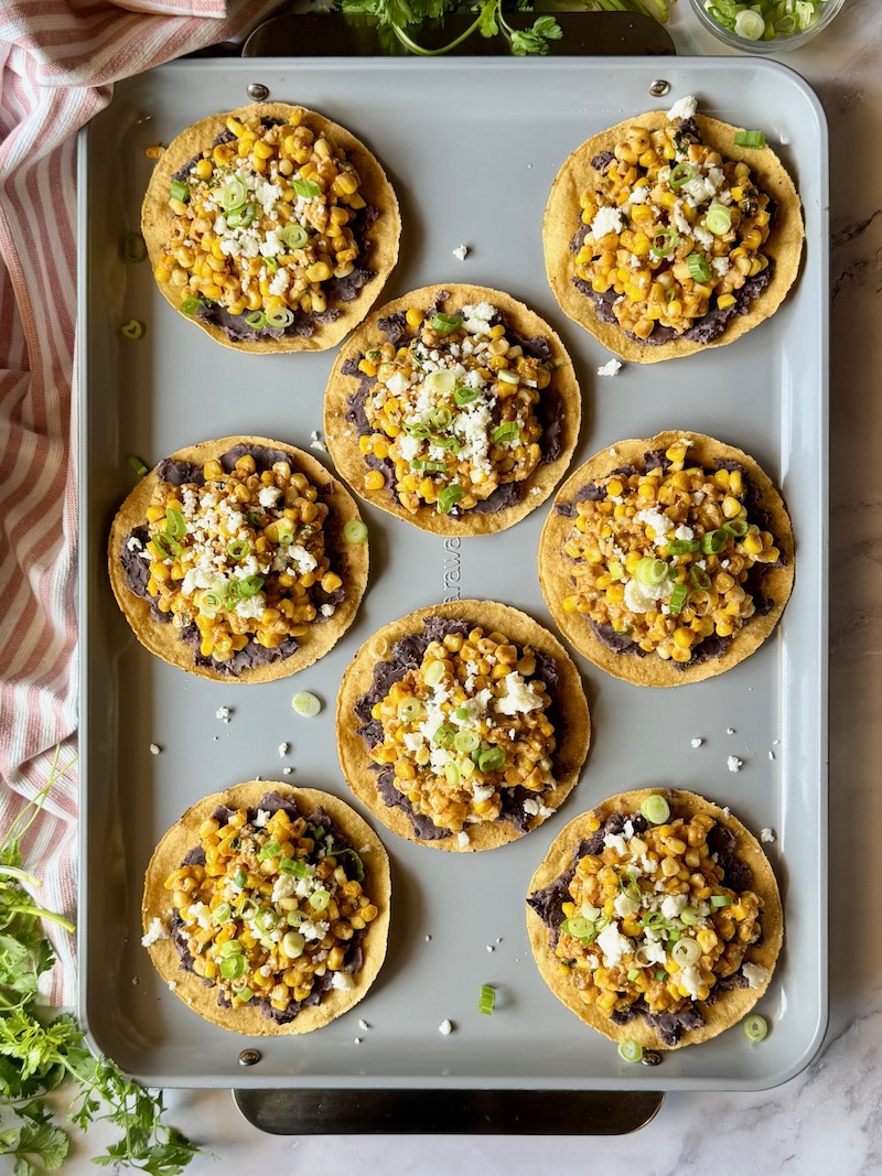 street corn tostadas on a sheet pan assembled. 