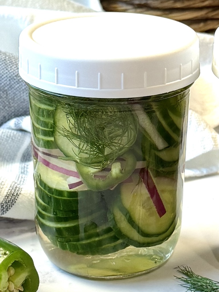 spicy pickled cucumbers in a jar with a lid