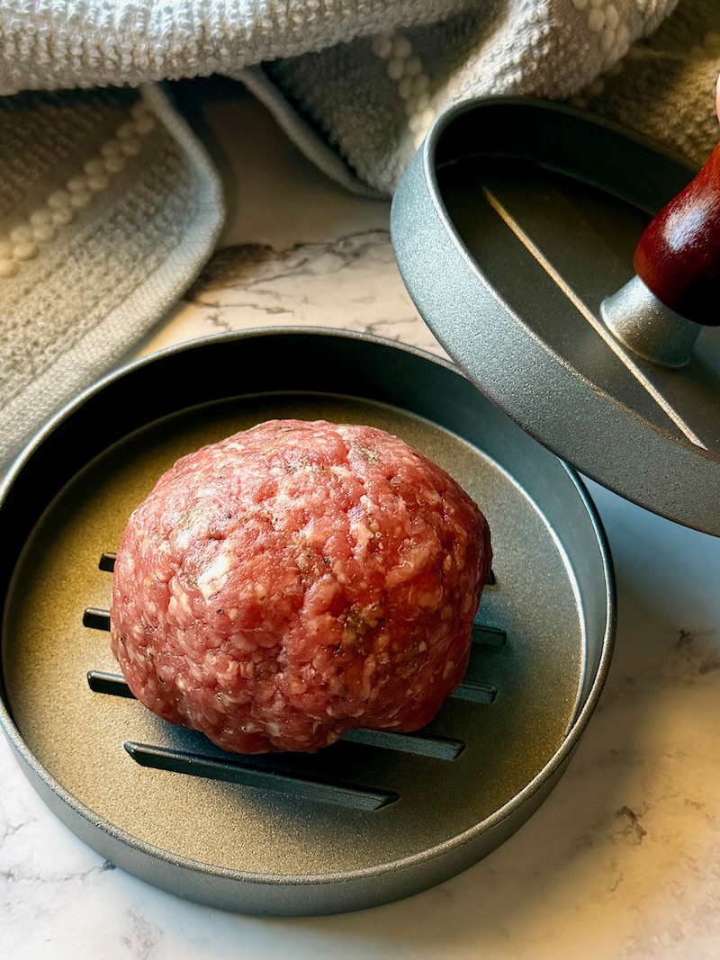 Beef ball inside a burger press