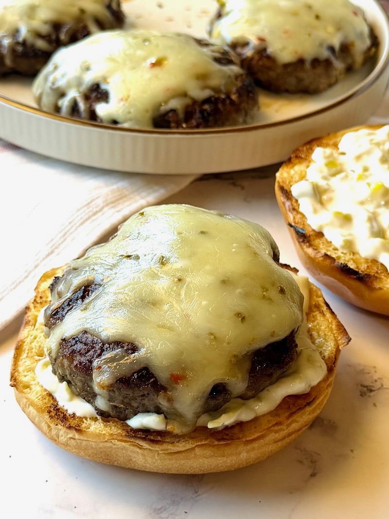 Beef patty on top of the bottom bun