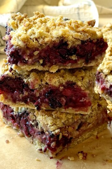 blackberry zucchini bars cut in squares and stacked
