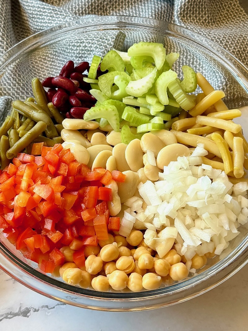 Salad ingredients layered in a serving bowl.
