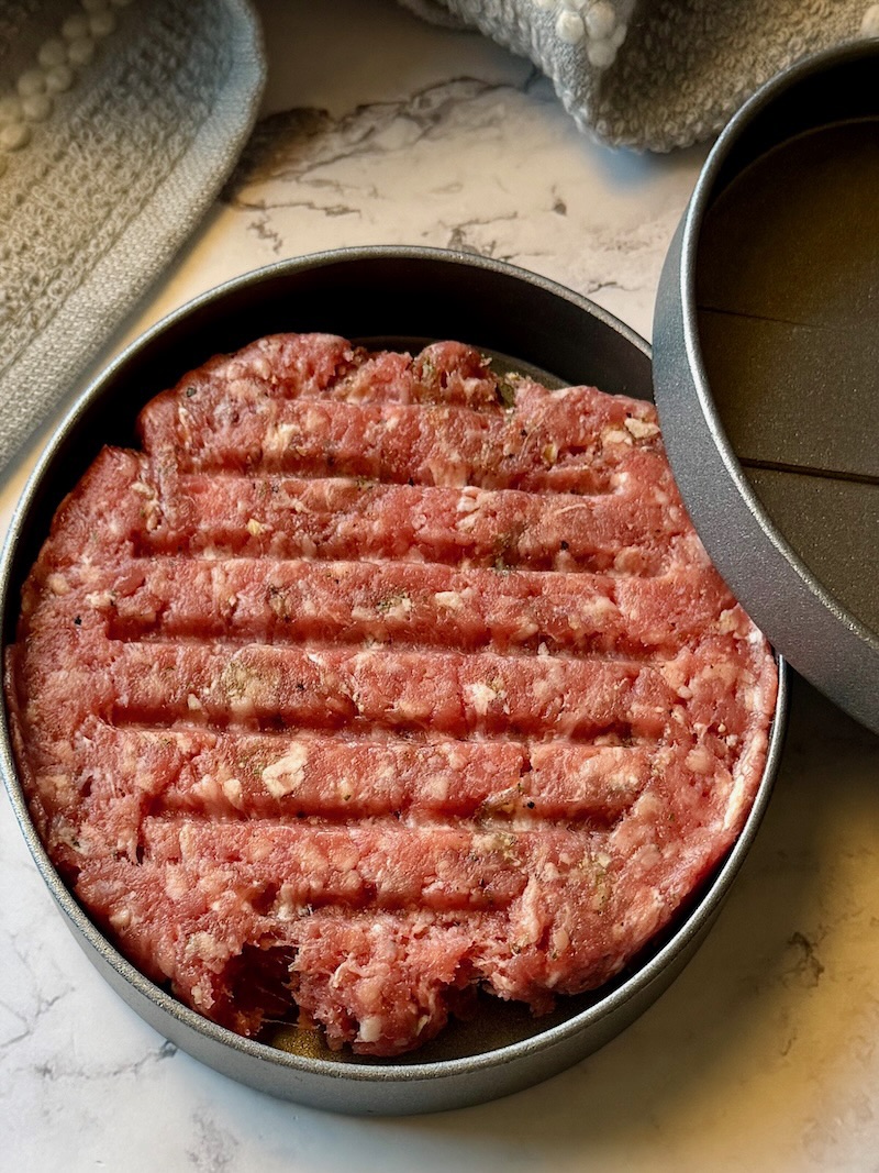 Burger pressed in a burger press.