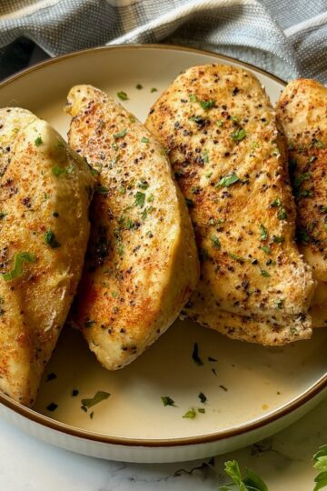 Slow cooker chicken breast cooked and on a plate