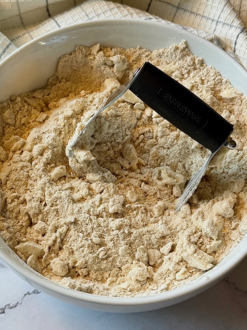 pastry cutter mixing butter with dry ingredients