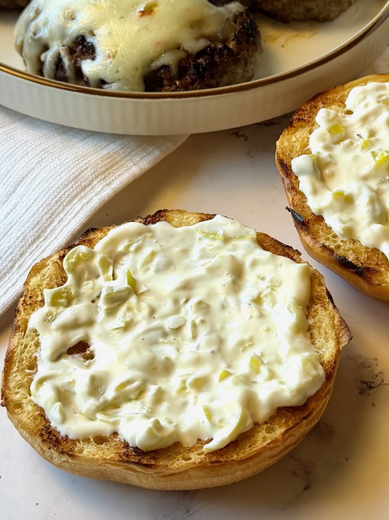 Creamy sauce on both halves of the buns.