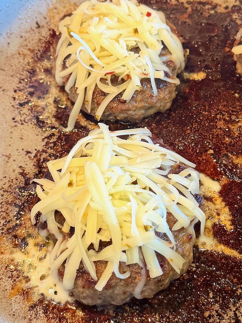 Burger patties with melted cheese.
