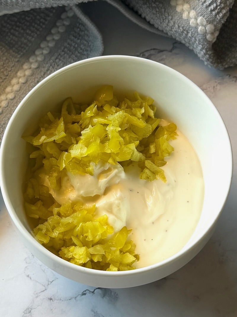 Mayo, ranch dressing, and pepperoncini in a small bowl