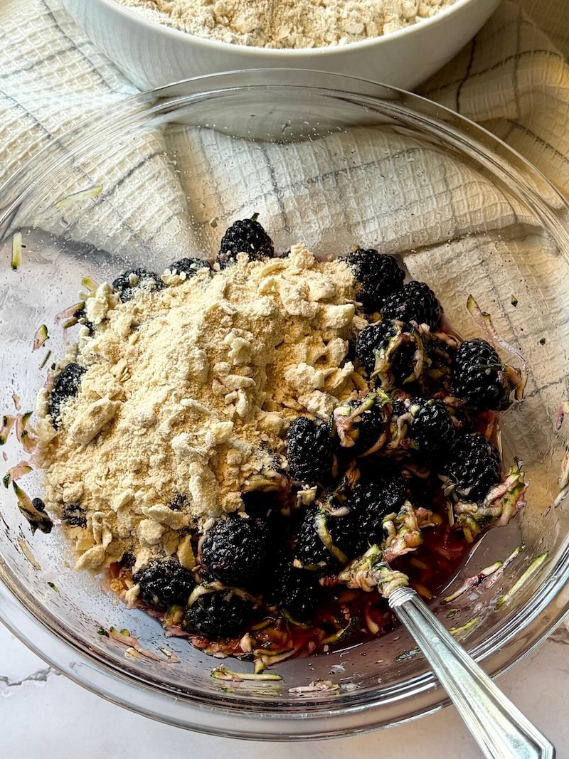 Some of the dry ingredients mixed with the berry mixture.