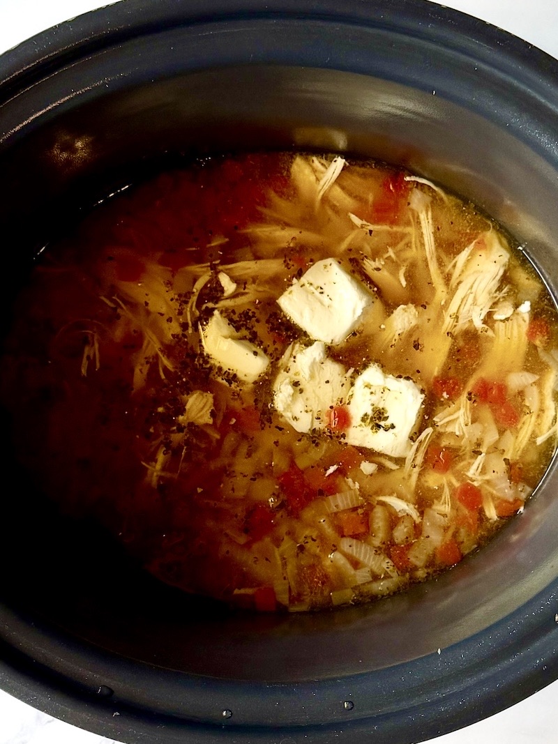 cream cheese in the slow cooker with the chicken