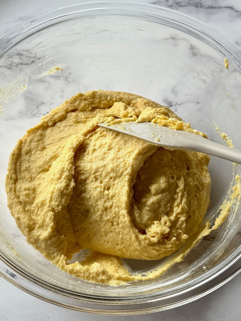 cornbread batter combined in a mixing bowl